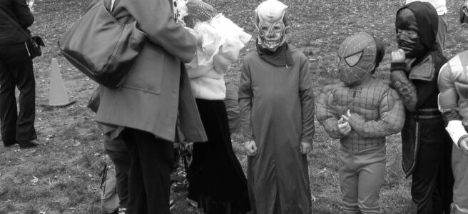 Children in Halloween costumes, with Death in the middle